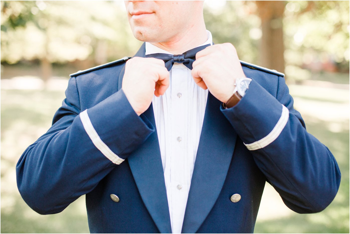 groom-in-his-air-force-uniform-fixing-his-bowtie
