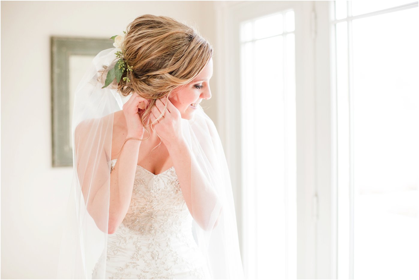 bride-putting-earrings-in-while-getting-ready-for-her-early-mountain-vineyard-wedding-charlottesville-virginia