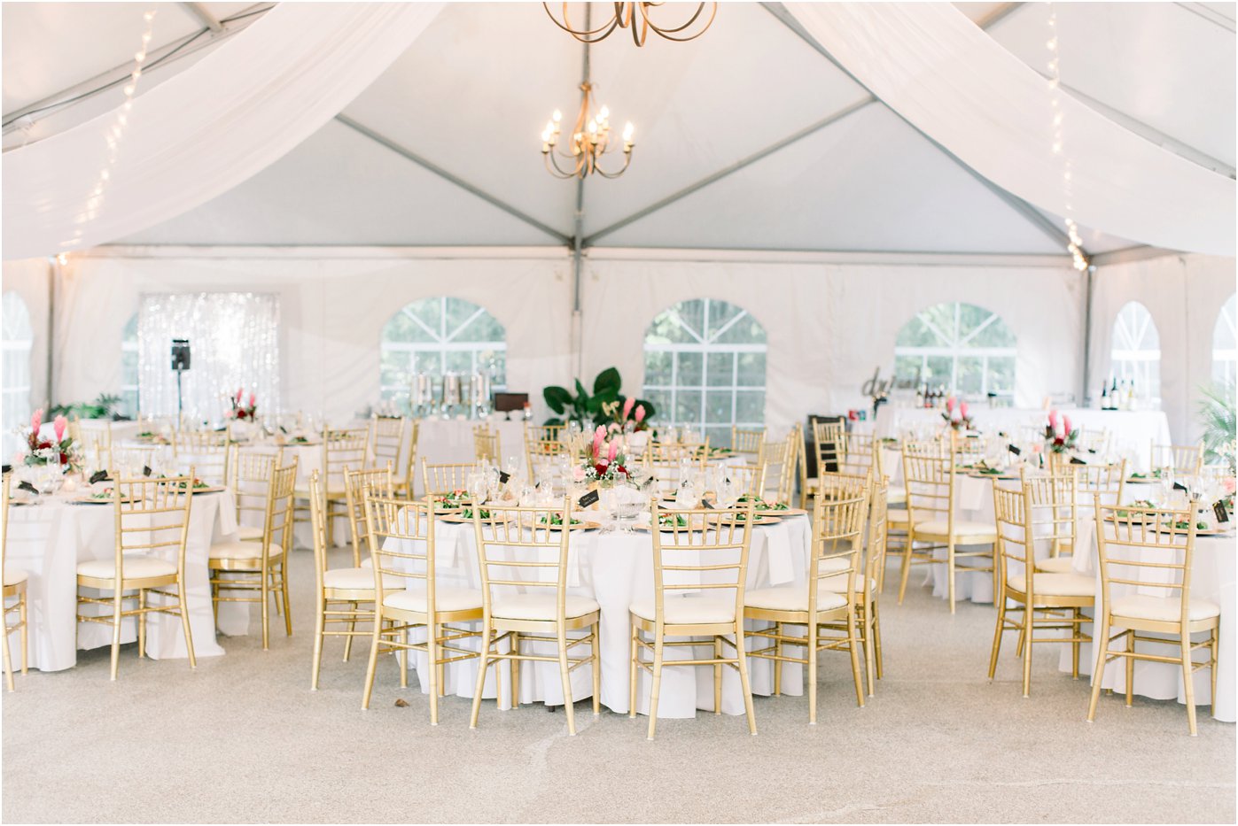 A tent wedding reception with gold chair accents at Rust Manor House. A beautiful wedding venue in Northern Virginia.