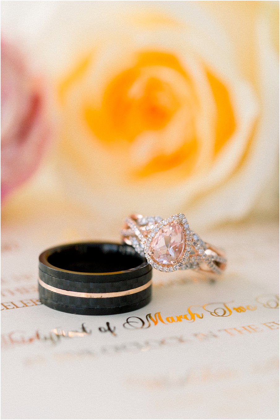 Rose Gold pear shaped blush diamond and his black wedding band with a rose gold stripe ring shot taken for a Walden Hall wedding 