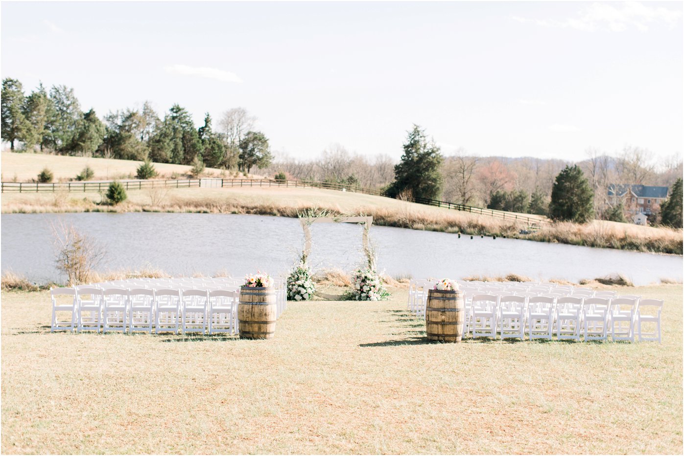 A crescent shaped arch way centers the ceremony space for the bride and groom's Walden Hall wedding. 