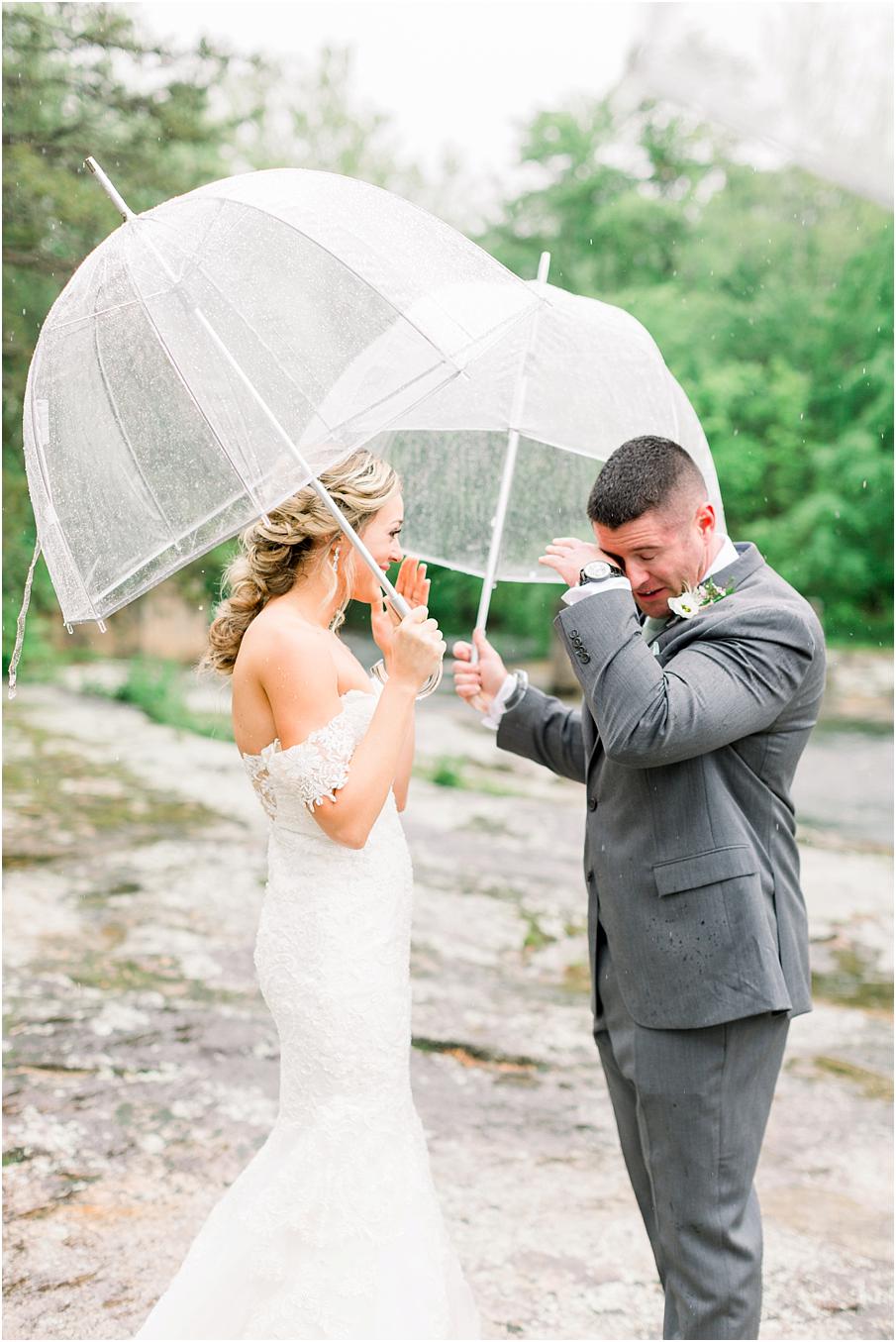 Bride and Groom seeing each other for the first time with umbrellas in hand to block the rain. Their Mill at Fine Creek wedding day was filled with beautiful rain portraits.