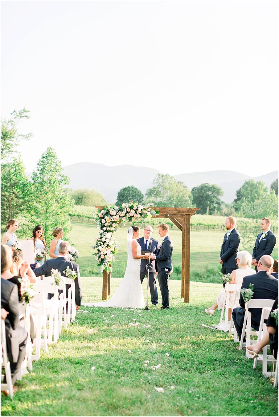 A stunning sunset wedding ceremony with mountains in the backdrop at Veritas Winery