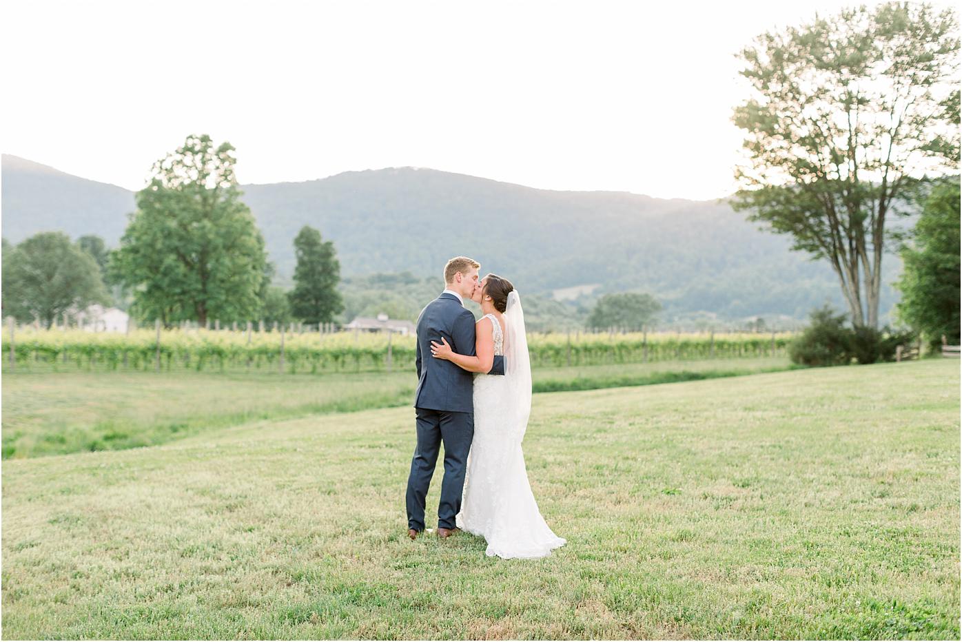 Bride and groom sharing a kiss after their Veritas Winery wedding at sunset