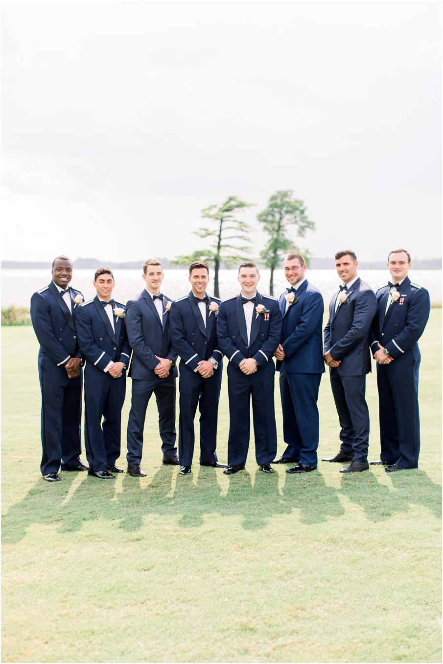 Groomsmen in military uniforms pose for a photo at Two Rivers Country Club