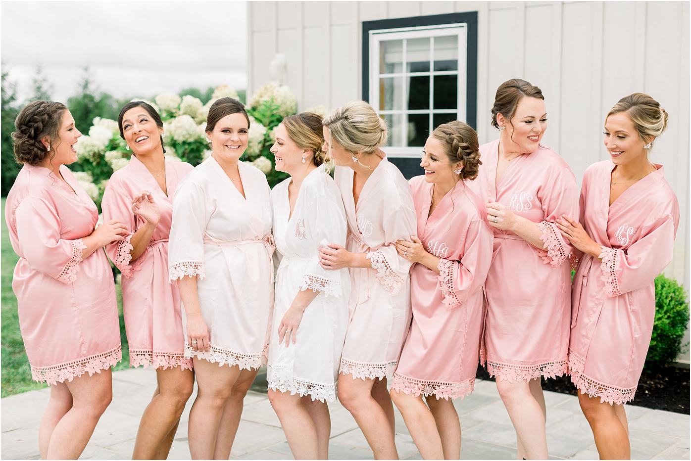 Robe picture with bride and bridesmaids in front of Shadow Creek wedding and events barn