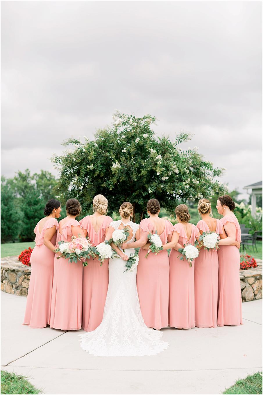 Blush bridesmaid dresses with white florals at Shadow Creek