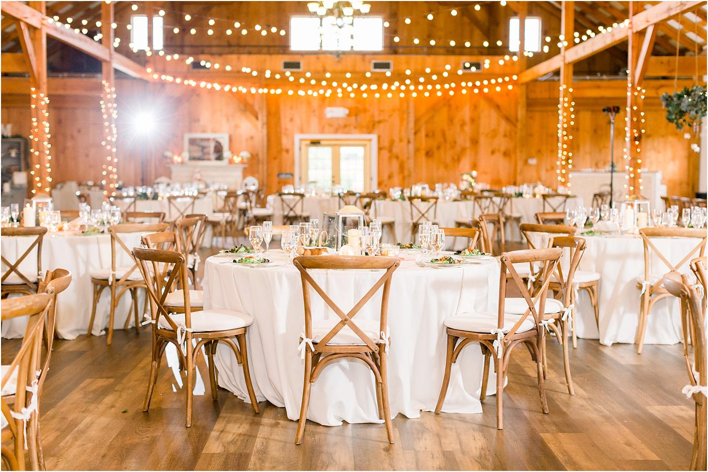 Shadow Creek's barn reception details with white table clothes, lantern center pieces and string lights