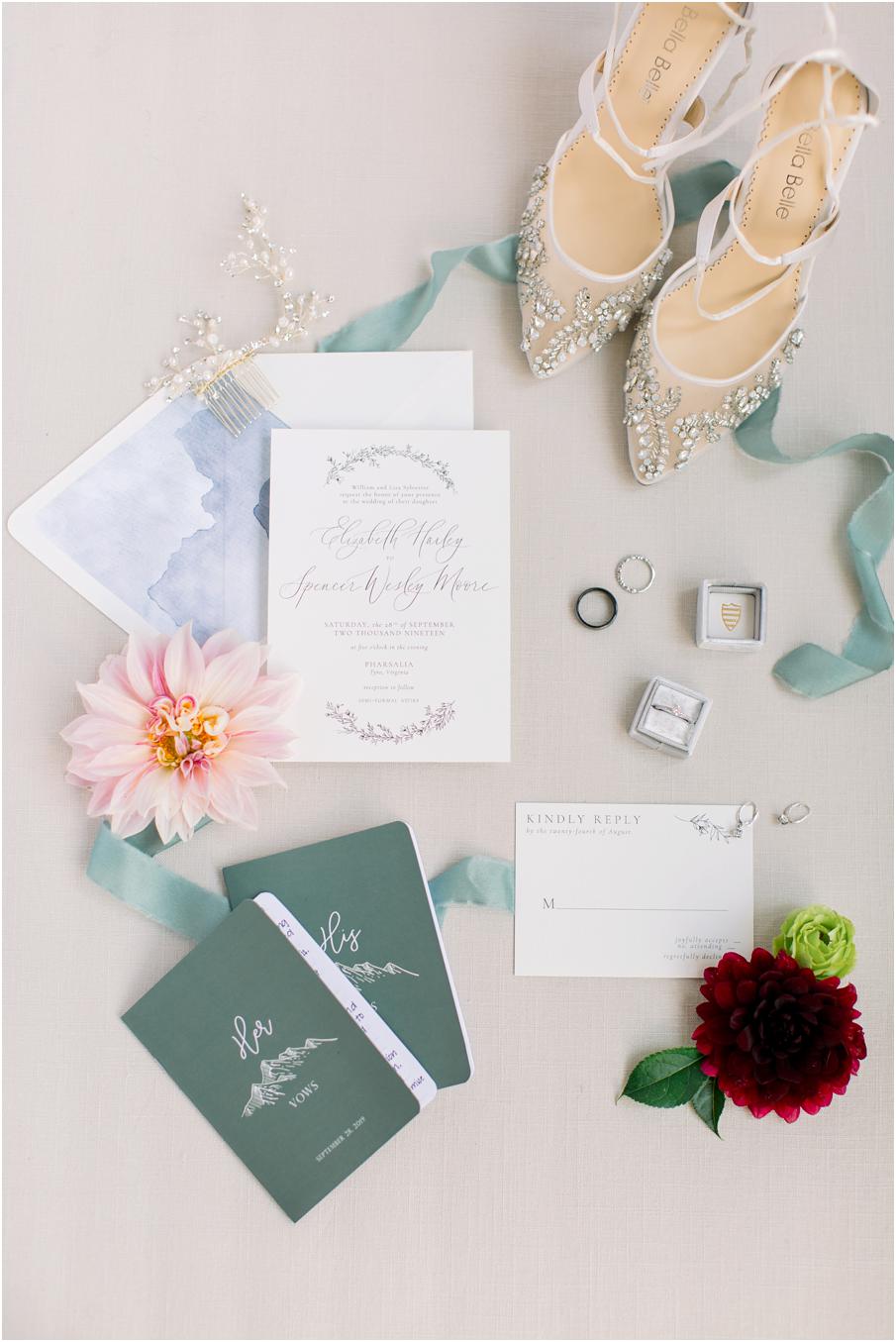 wedding details including invitations, shoes, vow books, and rings for a Pharsalia wedding day